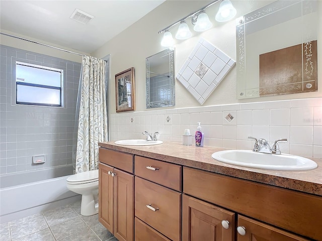 full bathroom featuring tile walls, tile patterned flooring, vanity, toilet, and shower / bath combo