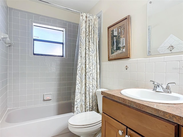 full bathroom with tile walls, vanity, shower / bath combination with curtain, and toilet