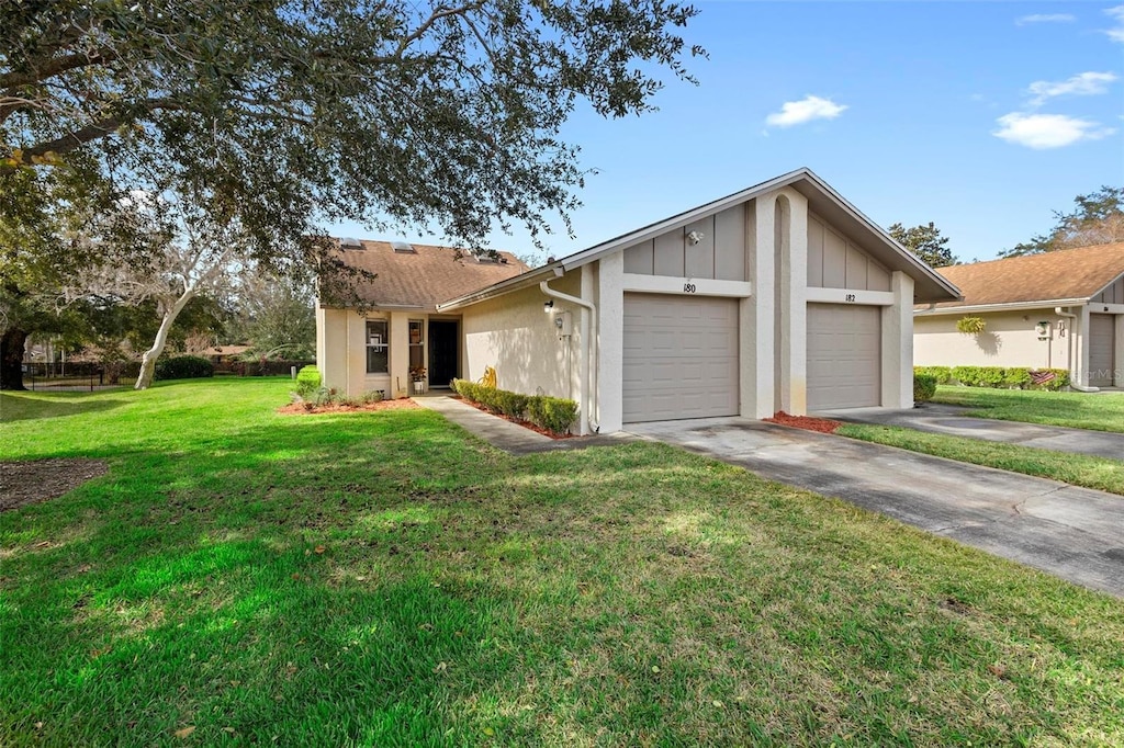 single story home featuring a garage and a front yard