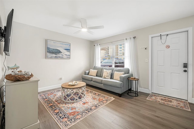 living room featuring wood-type flooring and ceiling fan