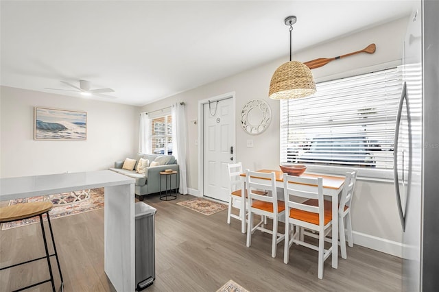 dining space featuring ceiling fan and light hardwood / wood-style flooring