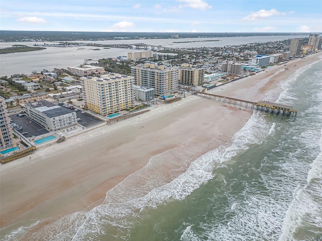 birds eye view of property featuring a view of the beach and a water view