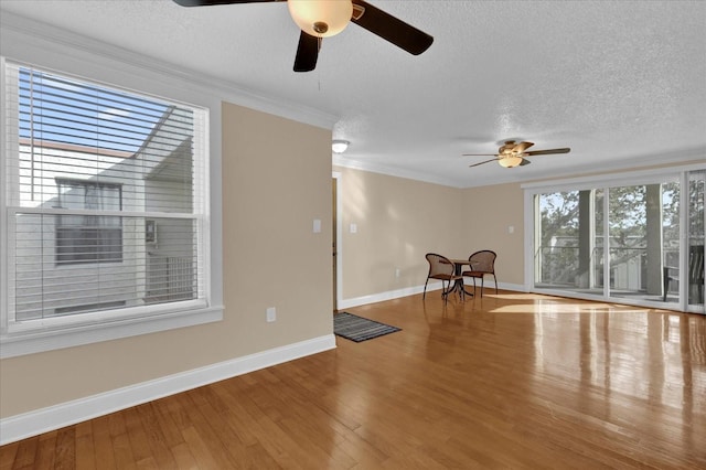 interior space with crown molding, hardwood / wood-style floors, and a textured ceiling