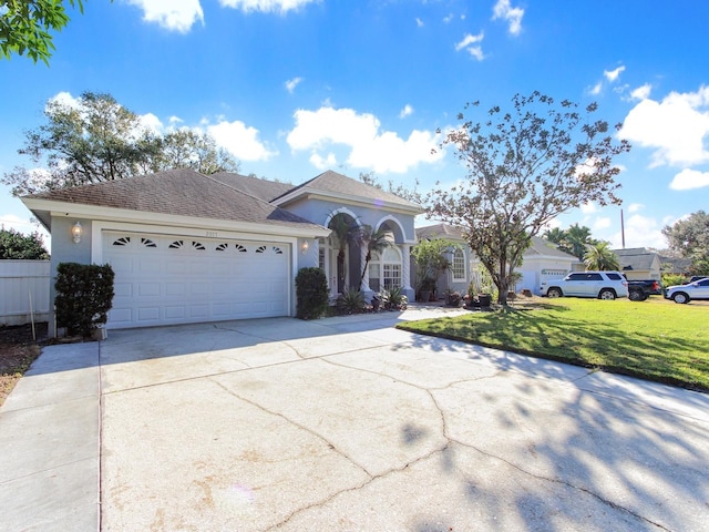 view of front of home featuring a garage and a front yard