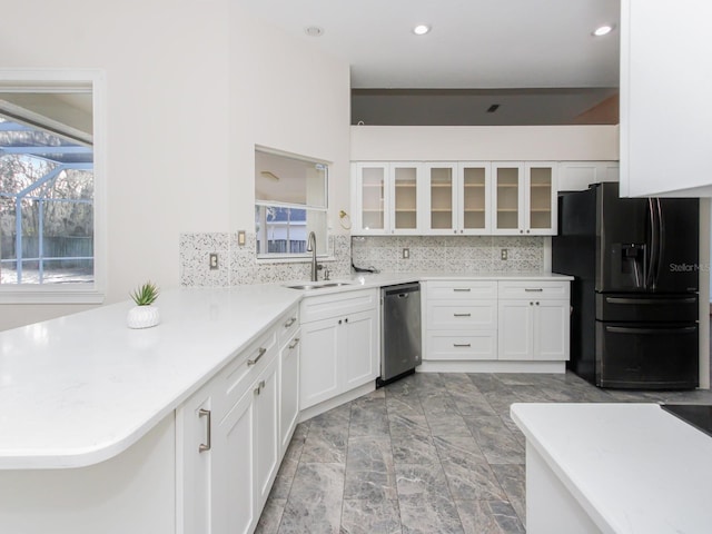 kitchen featuring white cabinetry, sink, backsplash, stainless steel dishwasher, and black fridge with ice dispenser