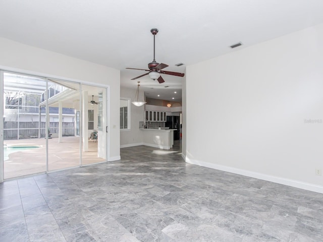 unfurnished living room featuring ceiling fan