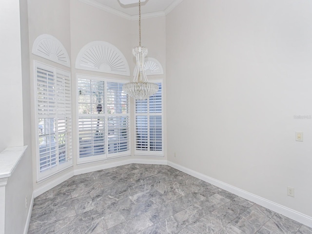 empty room with ornamental molding and a chandelier