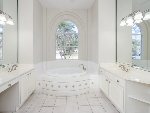 bathroom with vanity, tile patterned floors, and tiled bath