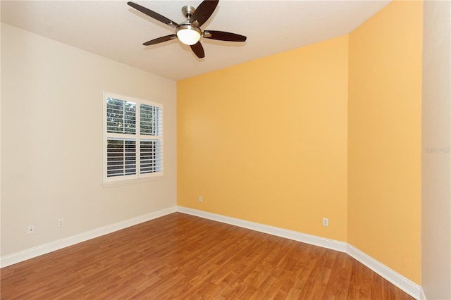 spare room with wood-type flooring and ceiling fan