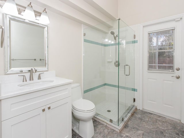 bathroom with vanity, toilet, and an enclosed shower