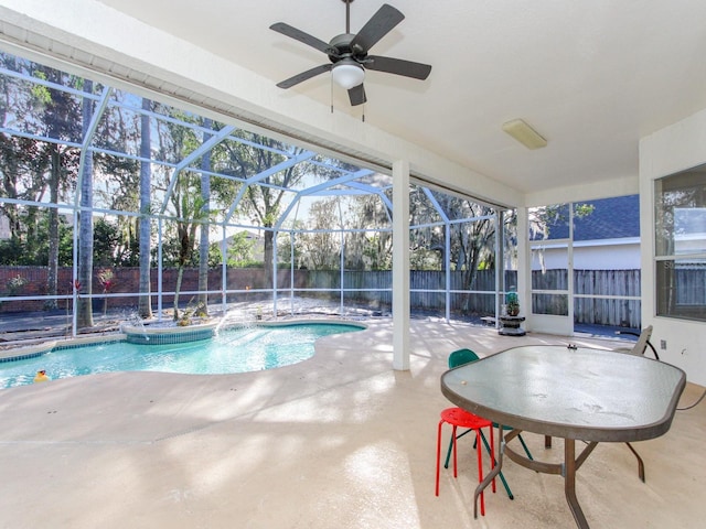 view of swimming pool with a patio, pool water feature, and glass enclosure