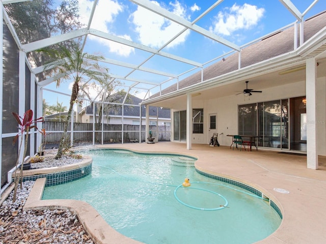 view of swimming pool with a lanai, a patio area, and ceiling fan