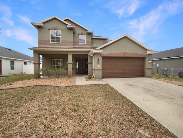 view of front of home with a porch, a garage, and a front lawn