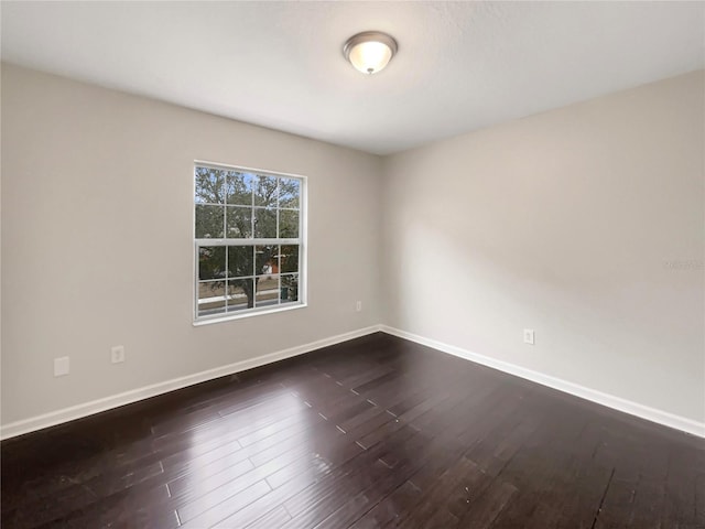 empty room featuring dark hardwood / wood-style flooring