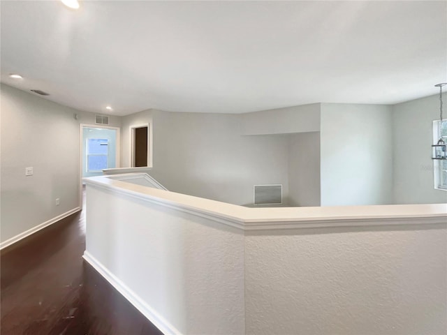 corridor featuring dark hardwood / wood-style floors