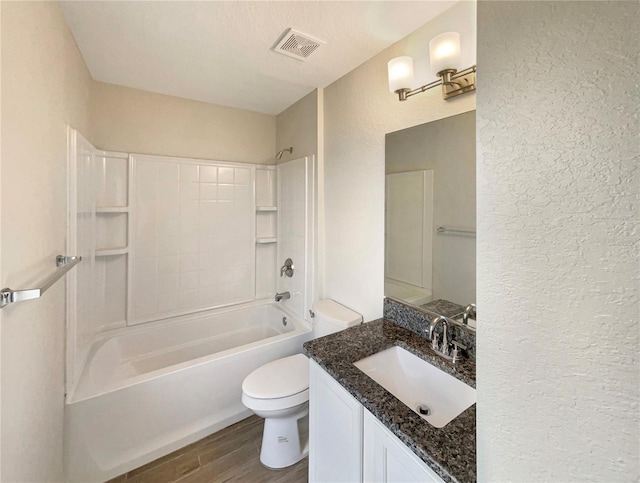 full bathroom with vanity, toilet, hardwood / wood-style floors, and shower / bathing tub combination