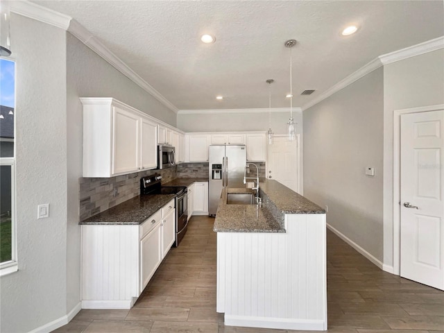 kitchen featuring sink, white cabinetry, a center island with sink, appliances with stainless steel finishes, and pendant lighting