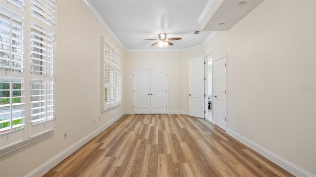 unfurnished bedroom featuring crown molding, ceiling fan, and light wood-type flooring