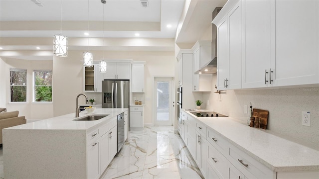 kitchen featuring a center island with sink, white cabinetry, sink, and pendant lighting