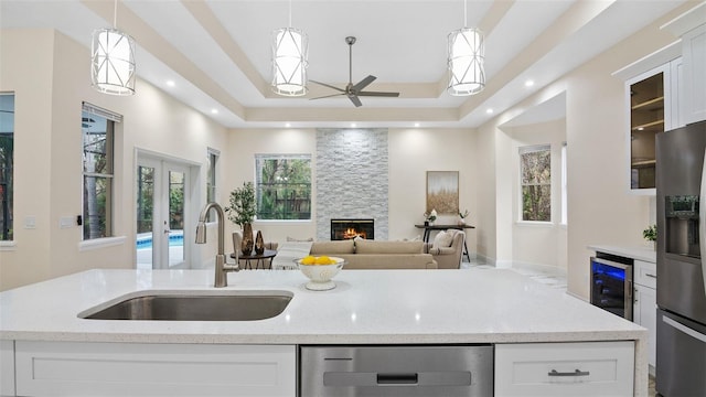 kitchen featuring white cabinetry, stainless steel appliances, and hanging light fixtures