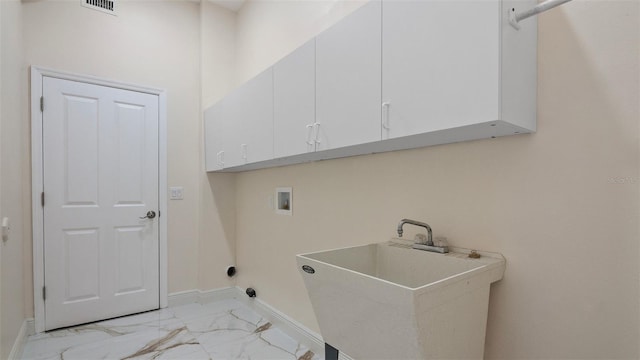 washroom with cabinets, washer hookup, and sink