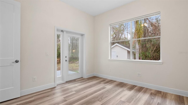 spare room featuring light hardwood / wood-style flooring