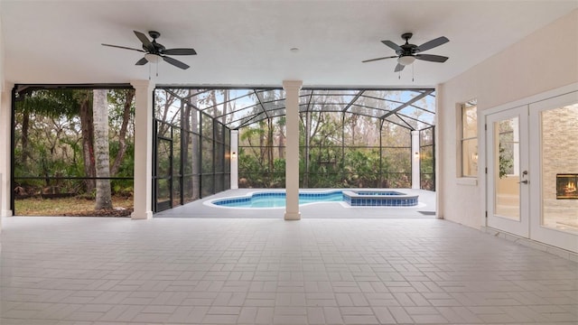 view of pool featuring french doors, a lanai, ceiling fan, and a patio area