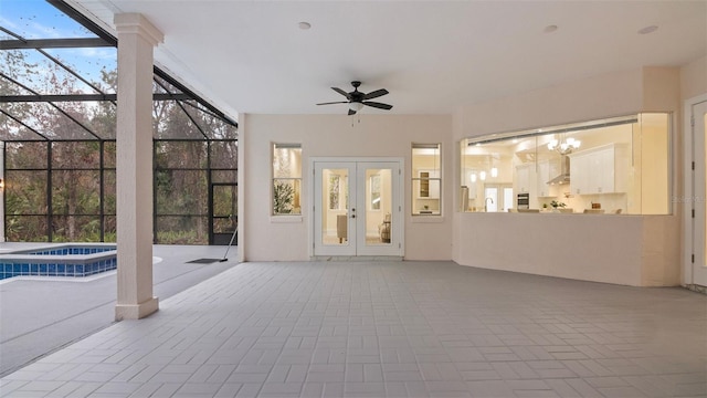 view of patio featuring french doors, ceiling fan, an in ground hot tub, and a lanai