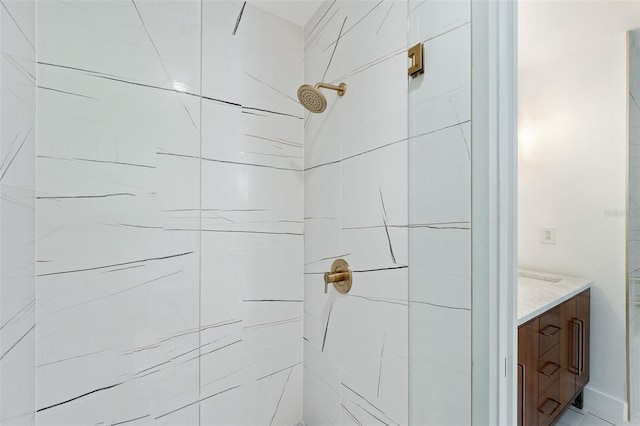 bathroom with vanity and a tile shower