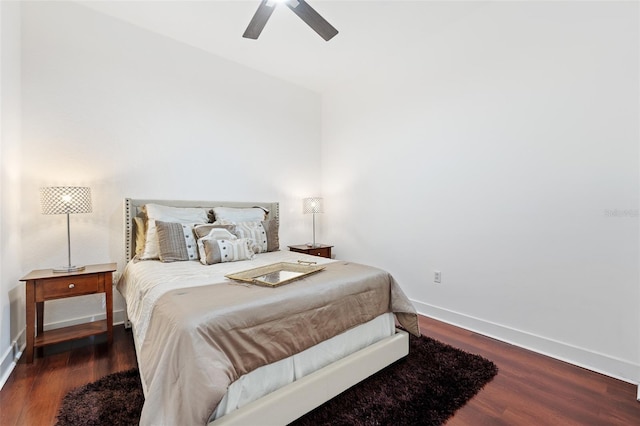 bedroom with dark hardwood / wood-style flooring and ceiling fan