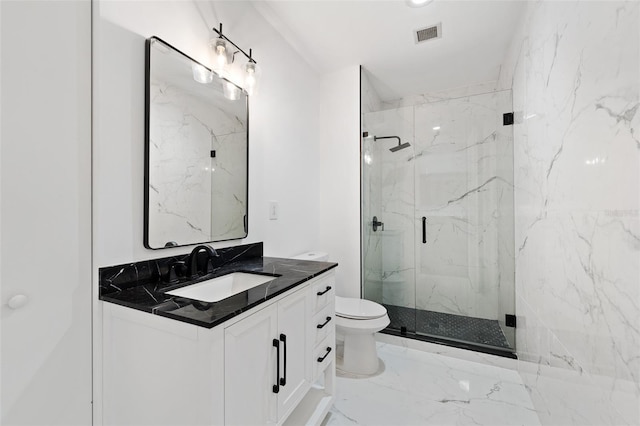 bathroom with vanity, a shower with shower door, and toilet