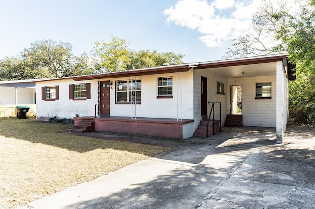 view of front facade with a carport and a front lawn