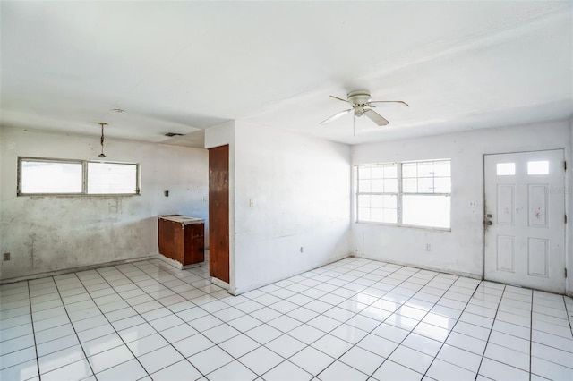 interior space featuring light tile patterned flooring and ceiling fan