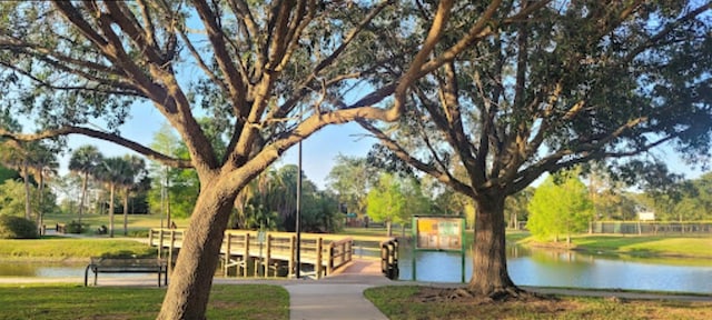 view of community with a water view and a yard