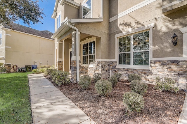 entrance to property with a lawn