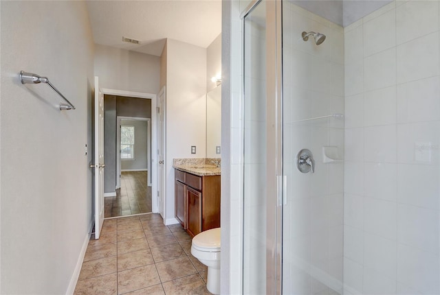 bathroom featuring toilet, vanity, tile patterned flooring, and walk in shower