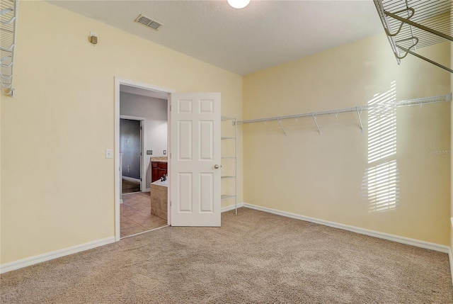 interior space featuring vaulted ceiling and light colored carpet