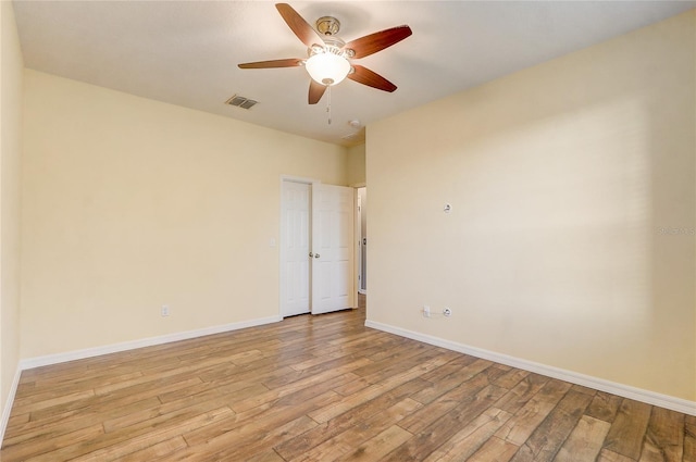 spare room with ceiling fan and light hardwood / wood-style floors