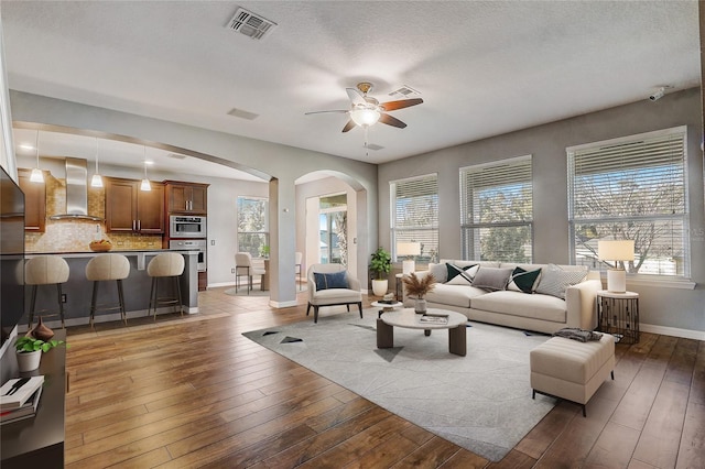 living room with hardwood / wood-style flooring and ceiling fan