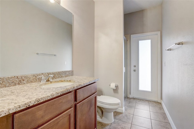 bathroom with toilet, a shower with door, tile patterned flooring, and vanity