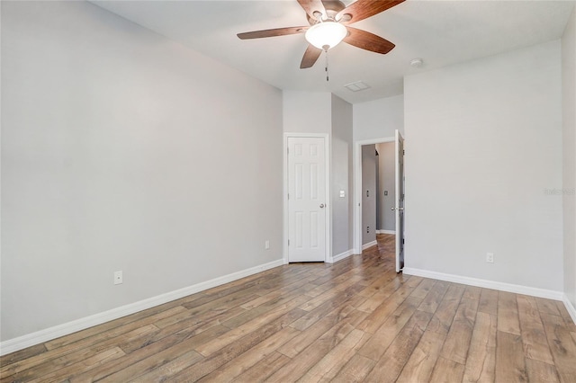 spare room featuring ceiling fan and light wood-type flooring