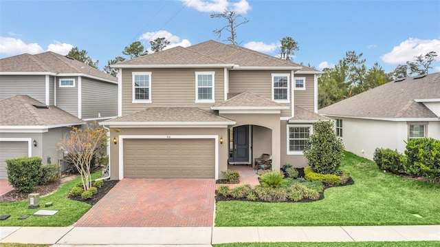 front facade featuring a garage and a front lawn