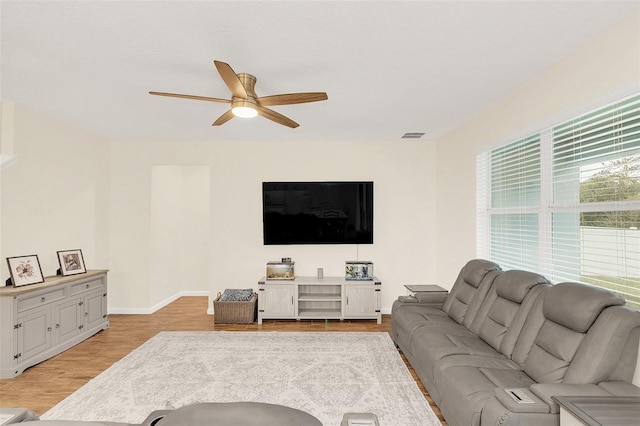 living room featuring ceiling fan and light wood-type flooring