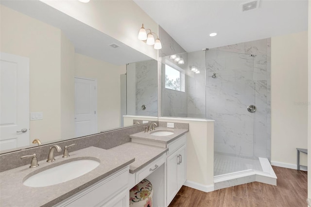 bathroom featuring vanity and tiled shower