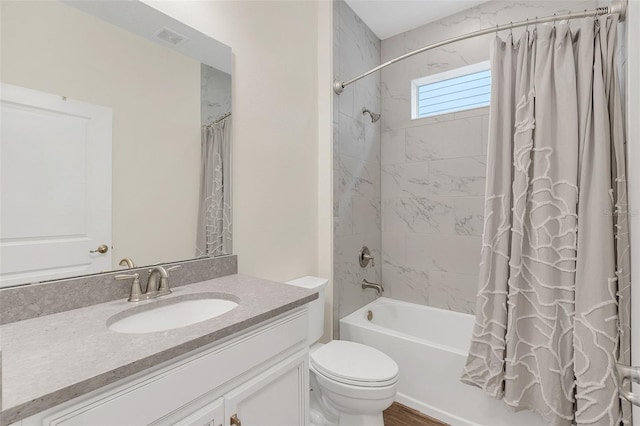 full bathroom featuring shower / bath combo, vanity, and toilet