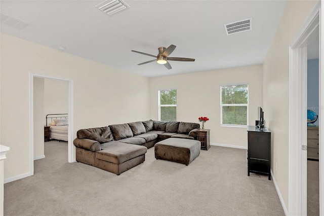 carpeted living room with ceiling fan