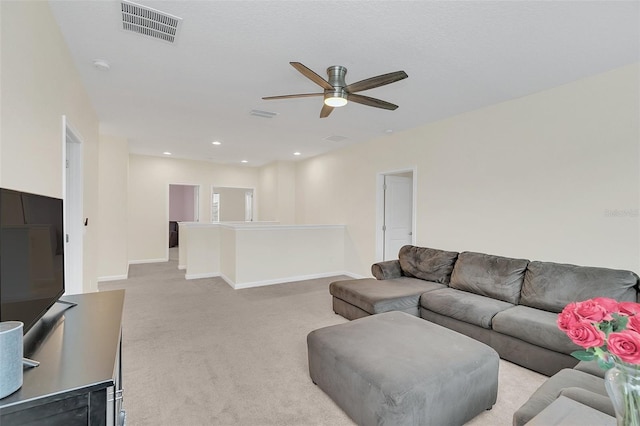 carpeted living room with ceiling fan