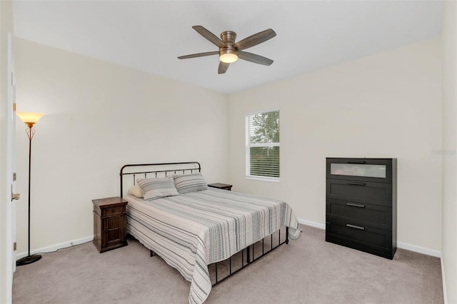 bedroom featuring ceiling fan and light carpet