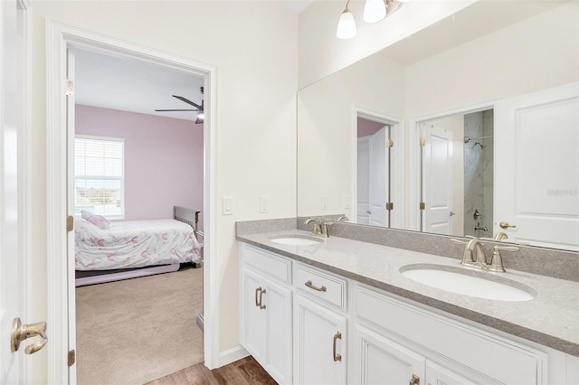 bathroom with wood-type flooring, vanity, and walk in shower