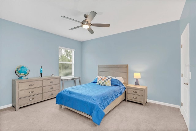 bedroom featuring light colored carpet and ceiling fan